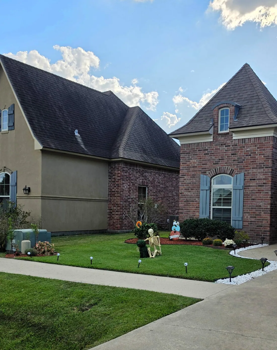 Freshly mowed and edged lawn with a clean rock-bordered bed, a recent SSB Lawn Services job